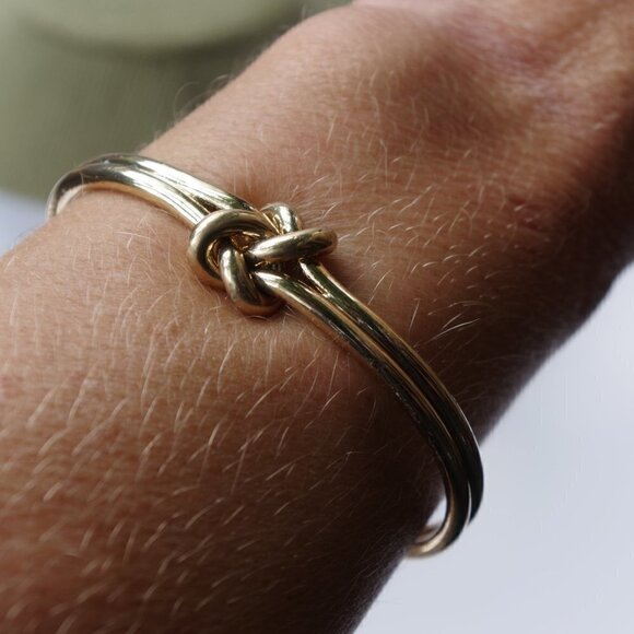 Jewelry - Women`s gold tone knot cuff bracelet. 2 1/2in. ID